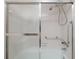 Bright bathroom with sliding glass shower doors, grab bars, and hand-held shower head at 4715 Bay Ne St # 323, St Petersburg, FL 33703