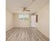Bright bedroom features wood-look flooring, plantation shutters, and a ceiling fan at 4715 Bay Ne St # 323, St Petersburg, FL 33703
