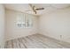 Light bedroom with wood-look floors, plantation shutters, and a ceiling fan at 4715 Bay Ne St # 323, St Petersburg, FL 33703