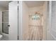 Bedroom with wood-look floors seen from hallway featuring an adjacent bathroom at 4715 Bay Ne St # 323, St Petersburg, FL 33703