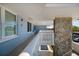 Hallway featuring a light blue wall and white geometric designed railing, leading to a rock facade at 4715 Bay Ne St # 323, St Petersburg, FL 33703
