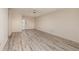 Spacious living room featuring modern wood-look flooring and a ceiling fan at 4715 Bay Ne St # 323, St Petersburg, FL 33703
