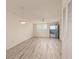 Bright living room with modern flooring, ceiling fan, modern light fixture, and access to the exterior at 4715 Bay Ne St # 323, St Petersburg, FL 33703
