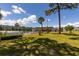 Pool area with lawn and palm tree landscaping at Winston Park Northeast at 4715 Bay Ne St # 323, St Petersburg, FL 33703