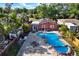 Aerial view showcasing a home with a custom pool, solar panels, and outdoor living at 5613 19Th S Ave, Gulfport, FL 33707