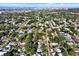 Expansive aerial view of a neighborhood with mature trees, well-maintained homes and a view of the bay in the distance at 5613 19Th S Ave, Gulfport, FL 33707
