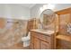 Bathroom features a wood cabinet and sink with an arched mirror at 5613 19Th S Ave, Gulfport, FL 33707