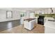 Bright kitchen featuring white cabinetry, stainless steel appliances, and tile flooring for a modern feel at 5613 19Th S Ave, Gulfport, FL 33707