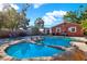 Backyard featuring a unique pool with rock features and comfortable lounge chairs at 5613 19Th S Ave, Gulfport, FL 33707