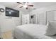 Cozy bedroom with white walls, tile floors, a ceiling fan, and ample closet space at 7206 N Howard Ave, Tampa, FL 33604