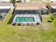 Aerial view of a home with a screened pool, showcasing its backyard and outdoor space at 736 Flamingo Dr, Apollo Beach, FL 33572