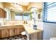 Bright bathroom featuring a large mirror, dual vanity, and ample counter space with modern fixtures at 736 Flamingo Dr, Apollo Beach, FL 33572