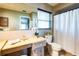Well-lit bathroom featuring a vanity, toilet, shower with curtain, and modern fixtures at 736 Flamingo Dr, Apollo Beach, FL 33572