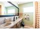 Bright bathroom featuring dual sinks, a large mirror, and modern fixtures at 736 Flamingo Dr, Apollo Beach, FL 33572
