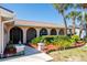 Charming home featuring a lush front yard with tropical landscaping, walkway, and stylish exterior lighting at 736 Flamingo Dr, Apollo Beach, FL 33572