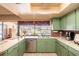 Updated kitchen with modern appliances, brick backsplash, and garden view at 736 Flamingo Dr, Apollo Beach, FL 33572