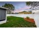 Fenced backyard with a landscaped garden bed at 895 Sea Holly Dr, Brooksville, FL 34604