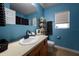 Bathroom with wood vanity, oval sink, and blue walls at 895 Sea Holly Dr, Brooksville, FL 34604