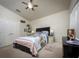 Bright bedroom boasts a ceiling fan, ample natural light, and neutral carpet flooring for a cozy feel at 895 Sea Holly Dr, Brooksville, FL 34604