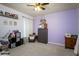 Bedroom with neutral carpet, ceiling fan, and accent wall at 895 Sea Holly Dr, Brooksville, FL 34604
