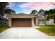Home with a well-manicured lawn and a two-car garage at 895 Sea Holly Dr, Brooksville, FL 34604
