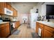 Functional kitchen with wood cabinets, a tile backsplash, and stainless steel appliances for a modern look at 895 Sea Holly Dr, Brooksville, FL 34604