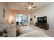 Cozy living room with a ceiling fan, plush carpet, and sliding glass doors leading to an outdoor space at 895 Sea Holly Dr, Brooksville, FL 34604