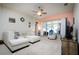 Comfortable living room features a ceiling fan, neutral carpet, and sliding glass doors to the backyard at 895 Sea Holly Dr, Brooksville, FL 34604