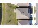 Overhead shot of a home, showing roof design and adjacent green space near pond at 9119 Forge Breeze Loop, Wesley Chapel, FL 33545
