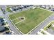 An aerial view showcasing a large community green space with a playground and meticulously maintained landscaping at 9119 Forge Breeze Loop, Wesley Chapel, FL 33545