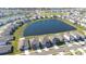 Aerial view of a neighborhood featuring houses surrounding a pond at 9119 Forge Breeze Loop, Wesley Chapel, FL 33545