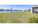 Spacious backyard with lush green grass and lake views, perfect for outdoor activities at 9119 Forge Breeze Loop, Wesley Chapel, FL 33545