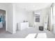 Well-lit bedroom with gray carpet, dresser, and window view at 9119 Forge Breeze Loop, Wesley Chapel, FL 33545