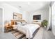 Modern bedroom with natural light, sleek furniture, and minimalist decor at 9119 Forge Breeze Loop, Wesley Chapel, FL 33545