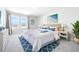 Serene bedroom with large windows, a plush bed, and stylish blue accents at 9119 Forge Breeze Loop, Wesley Chapel, FL 33545
