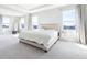 Spacious bedroom with tray ceiling and waterfront views at 9119 Forge Breeze Loop, Wesley Chapel, FL 33545