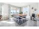 Dining area with wood table, blue chairs, and sliding doors leading to a outdoor patio, featuring a view of the lake at 9119 Forge Breeze Loop, Wesley Chapel, FL 33545