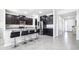 Modern kitchen features dark wood cabinets, granite countertops, stainless steel appliances and a breakfast bar with seating at 9119 Forge Breeze Loop, Wesley Chapel, FL 33545
