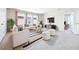 A bright living room with modern furniture, stylish decor, and large windows offering ample natural light at 9119 Forge Breeze Loop, Wesley Chapel, FL 33545