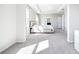 An airy bedroom with a plush bed, tray ceilings, and abundant natural light, creating a comfortable and inviting space at 9119 Forge Breeze Loop, Wesley Chapel, FL 33545