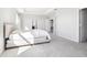 An airy bedroom with a plush bed, tray ceilings, and abundant natural light, creating a comfortable and inviting space at 9119 Forge Breeze Loop, Wesley Chapel, FL 33545