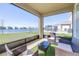 Screened-in patio features elegant furniture and stunning water views overlooking a beautiful lake at 9119 Forge Breeze Loop, Wesley Chapel, FL 33545