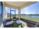 Relax on the screened-in patio with comfortable seating and enjoy the scenic water view at 9119 Forge Breeze Loop, Wesley Chapel, FL 33545