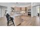 Bright kitchen with breakfast bar, wooden cabinetry, stainless steel appliances and marble backsplash at 9515 Silverthorn Rd, Seminole, FL 33777