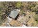 Aerial view of two houses surrounded by lush trees showcasing the neighborhood's greenery at 10113 Huntley St, New Port Richey, FL 34654