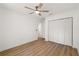 Inviting bedroom with a ceiling fan and closet, featuring modern hardwood flooring at 10113 Huntley St, New Port Richey, FL 34654