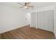 Bright bedroom with a ceiling fan and closet, features modern hardwood flooring at 10113 Huntley St, New Port Richey, FL 34654