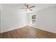 Minimal bedroom with wood flooring, a ceiling fan, and a bright window providing natural light at 10113 Huntley St, New Port Richey, FL 34654