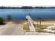 Boat ramp leading to a calm lake, with signage indicating swimming and diving restrictions at 10113 Huntley St, New Port Richey, FL 34654