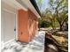 Side view of a brick home featuring a white front door and a well maintained walkway at 10113 Huntley St, New Port Richey, FL 34654